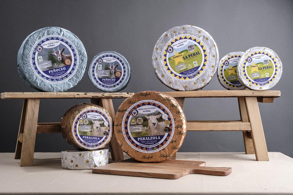 Still life of artisanal cheeses from Quesos La Peral, showcasing the family